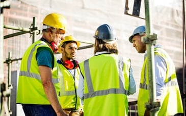 Team members discuss how to improve collaboration within a construction project. 