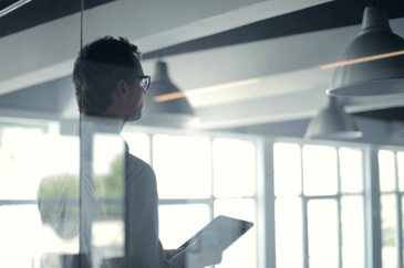 A man with a tablet looking at construction management software 