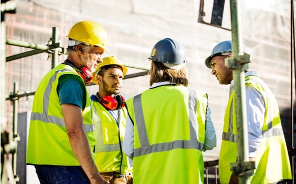 Team members discuss how to improve collaboration within a construction project.